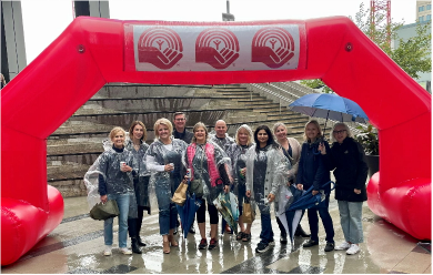 PBL staff posing under the United Way inflatable arch